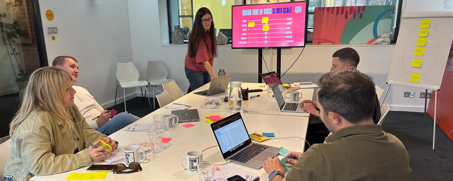 A team of marketers around a table during a content marketing strategy exercise